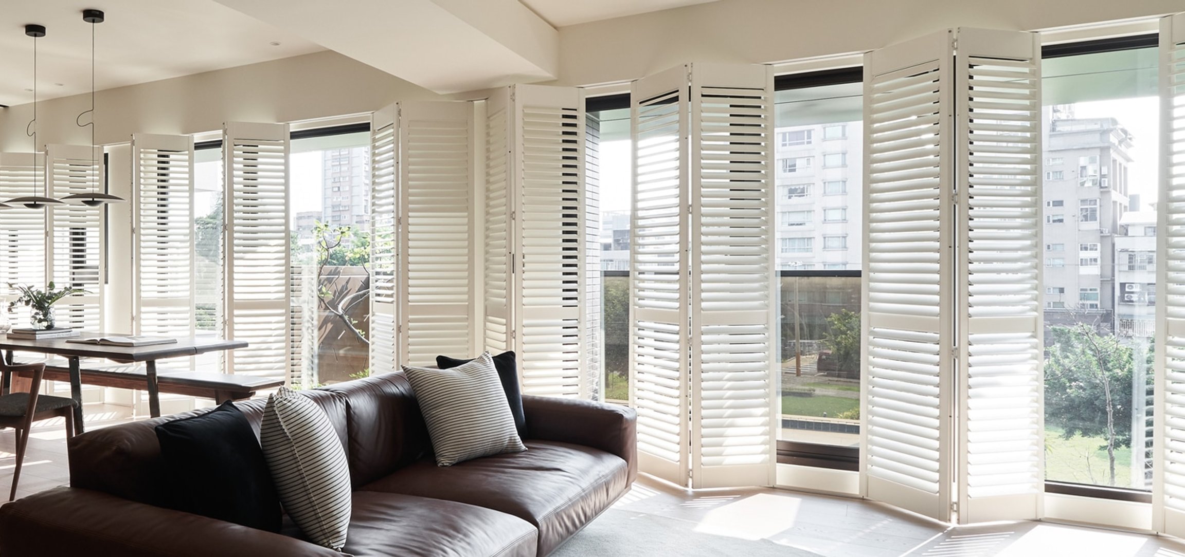 Norman Woodlore plantation shutters across a row of windows.